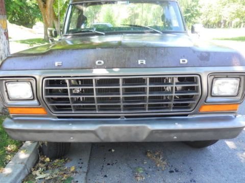 1979 Ford Bronco - The front grille of a 1979 Ford Bronco is visible, with the 'FORD' lettering on the hood above it.
