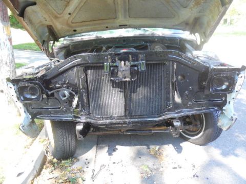 1979 Ford Bronco - Front view of a 1978 Ford Bronco, hood open, revealing the engine bay and radiator.