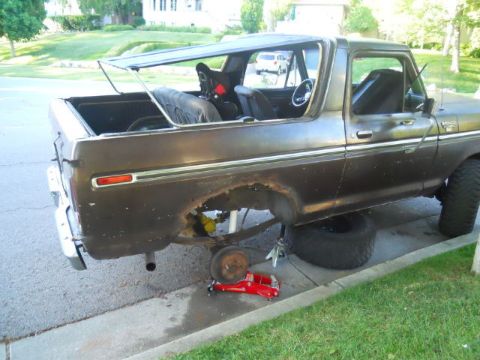 1979 Ford Bronco - This 1979 Ford Bronco is shown from the side, with its soft top removed and wheels off for repairs.