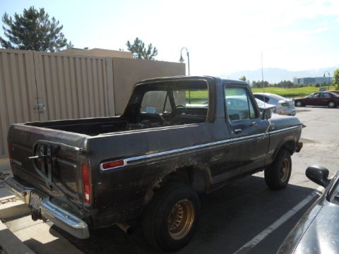 1979 Ford Bronco - This 1979 Ford Bronco is viewed from the rear quarter, showing its dark paint and spare tire carrier.