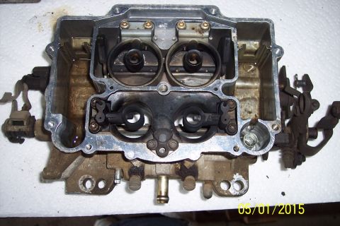 1973 Ford F-250 - Carburetor disassembled for rebuild, revealing its internal workings and parts.