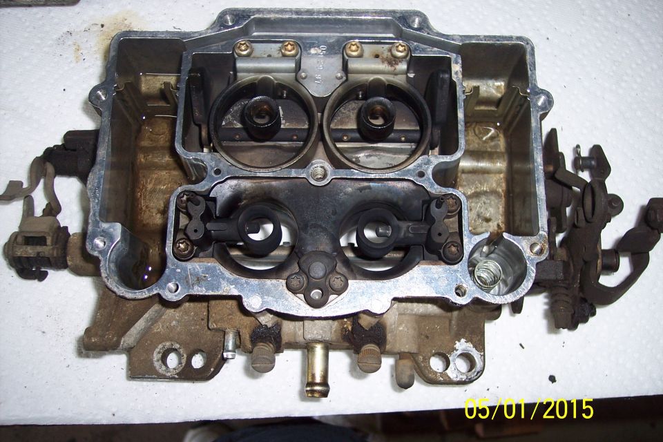 Holley carburetor with top removed, showing internal components and fuel bowls
