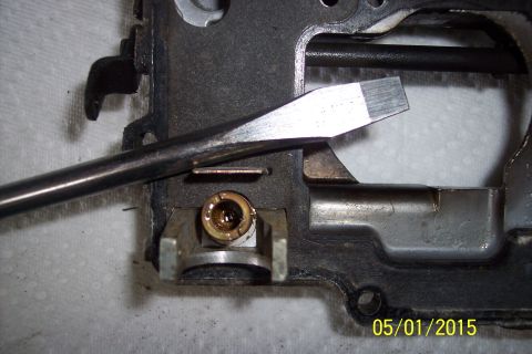 1973 Ford F-250 - A screwdriver is used to adjust or inspect a part of a carburetor.