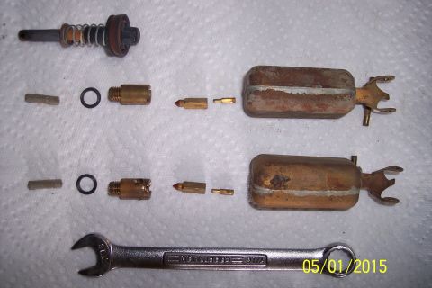1973 Ford F-250 - Disassembled carburetor parts laid out on a white cloth next to a wrench.