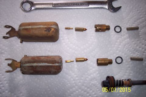 1973 Ford F-250 - Disassembled carburetor components are laid out on a white surface next to a wrench.