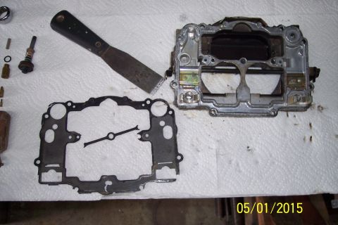 1973 Ford F-250 - Disassembled carburetor components and gasket are ready for rebuild.