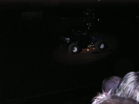 1996 Ford Bronco - A monster truck is shown at night with sparks flying from its undercarriage.