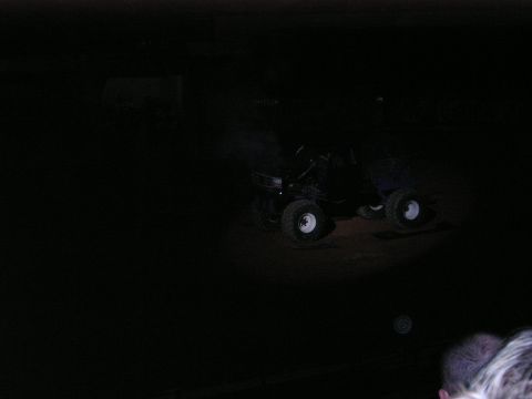 1996 Ford Bronco - A monster truck with oversized wheels is illuminated in the dark.