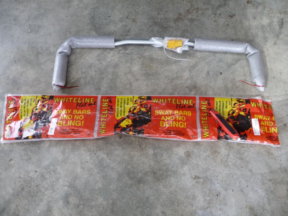 Whiteline sway bar in packaging with red and yellow graphics. Text reads 'SWAY BARS AND NO BLING!'