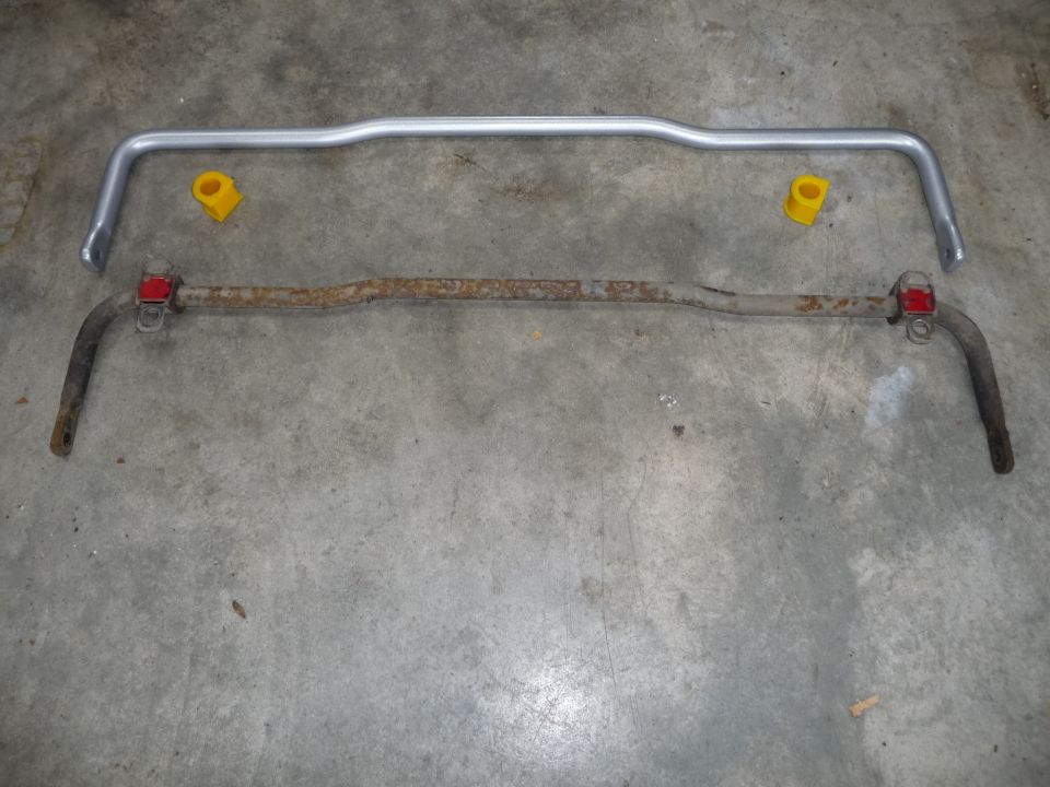 New silver sway bar above old rusty sway bar with yellow bushings