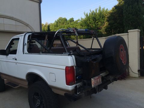 1996 Ford Bronco - This modified Ford Bronco features a roll cage and a spare tire with a prominent OU logo on the rear.