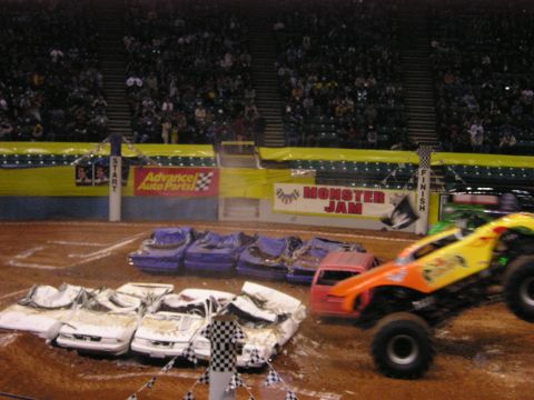 1996 Ford Bronco - A monster truck event with several crushed cars lined up for destruction.