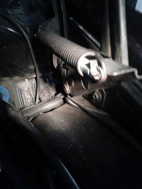 1979 Ford Ranchero - The photo shows a close-up view of the hood latch mechanism, including a spring and various wires.