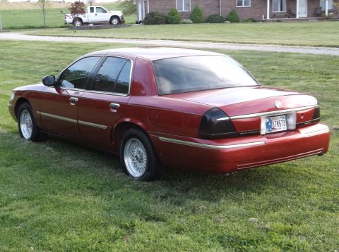 1999 Mercury Grand Marquis - This 1999 Mercury Grand Marquis is shown from the rear, parked on a grassy lawn.