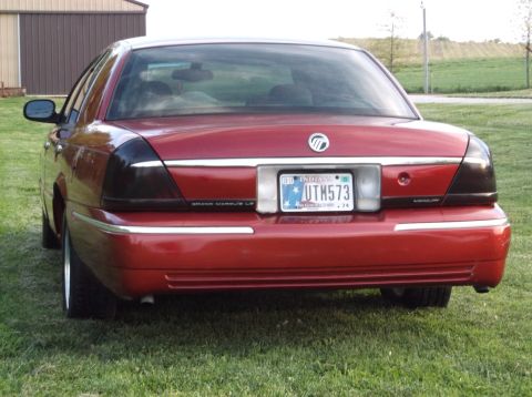 1999 Mercury Grand Marquis - Rear view of a red Mercury Grand Marquis sedan with tinted taillights and an Indiana license plate.