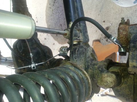 1996 Ford Bronco - Suspension system detail showing a shock absorber, coil spring, and brake line connections.