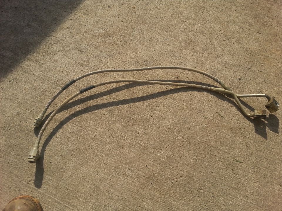 two metal brake lines with connectors