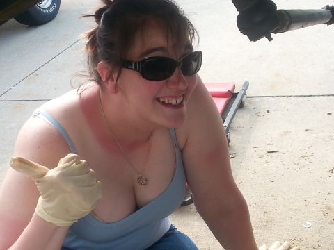 1996 Ford Bronco - A woman with sunglasses and prominent sunburnt shoulders gives a thumbs up while wearing gloves.