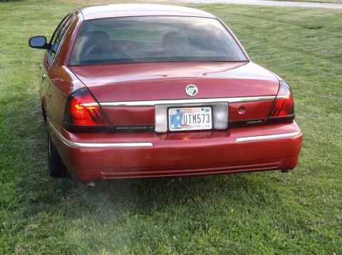 1999 Mercury Grand Marquis - Rear view of a red Mercury Grand Marquis LS with chrome trim and tinted taillights.
