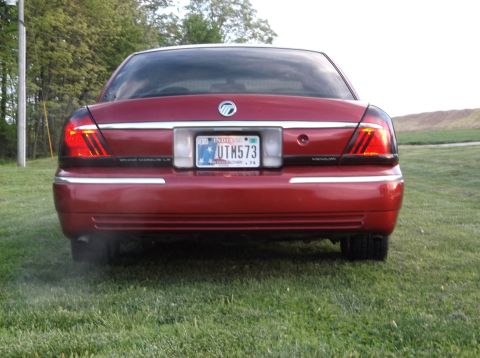 1999 Mercury Grand Marquis - Rear view of a red 1999 Mercury Grand Marquis sedan with an Indiana license plate.