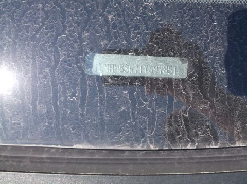 1999 Mercury Grand Marquis - The VIN is visible on the dusty windshield of a vehicle.