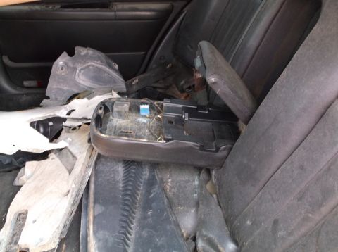 1999 Mercury Grand Marquis - Interior view of a car with the center console removed and debris scattered.