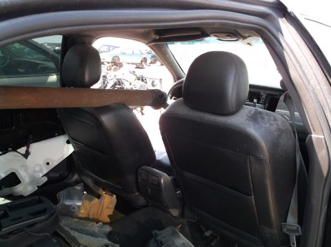 1999 Mercury Grand Marquis - Interior of a 1999 Mercury Grand Marquis with a driveshaft laid across the front seats.