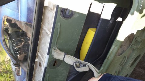 1993 Ford Bronco - Interior view of a vehicle's cargo area, showing green panels and a yellow item.