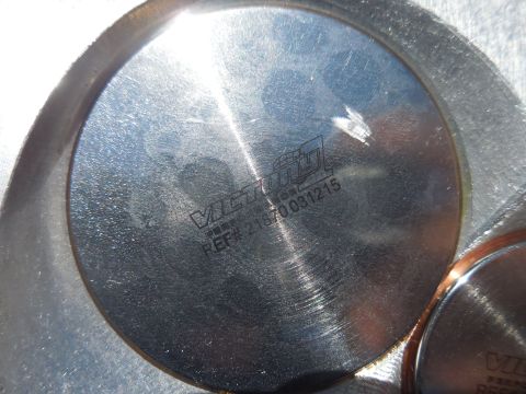 1979 Ford Bronco - Close-up of an engine cylinder head with a visible part number and logo.