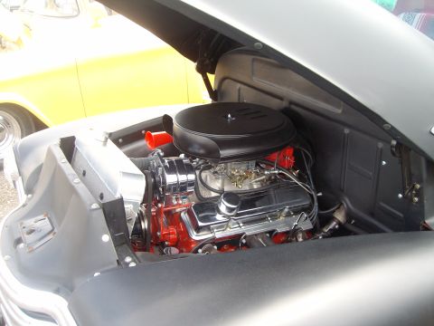 2004 Ford Crown Victoria - Close-up of a V8 engine in a classic car's engine bay, with another vehicle in the background.