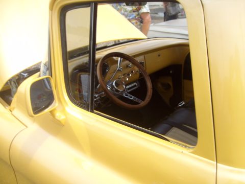 2004 Ford Crown Victoria - Interior view of a yellow custom hot rod, showing the dashboard and steering wheel.