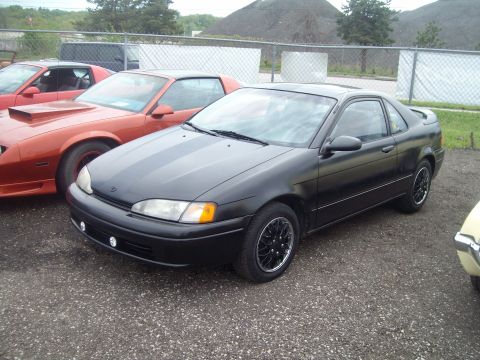 2004 Ford Crown Victoria - Black coupe with racing stripes and aftermarket wheels parked outdoors.
