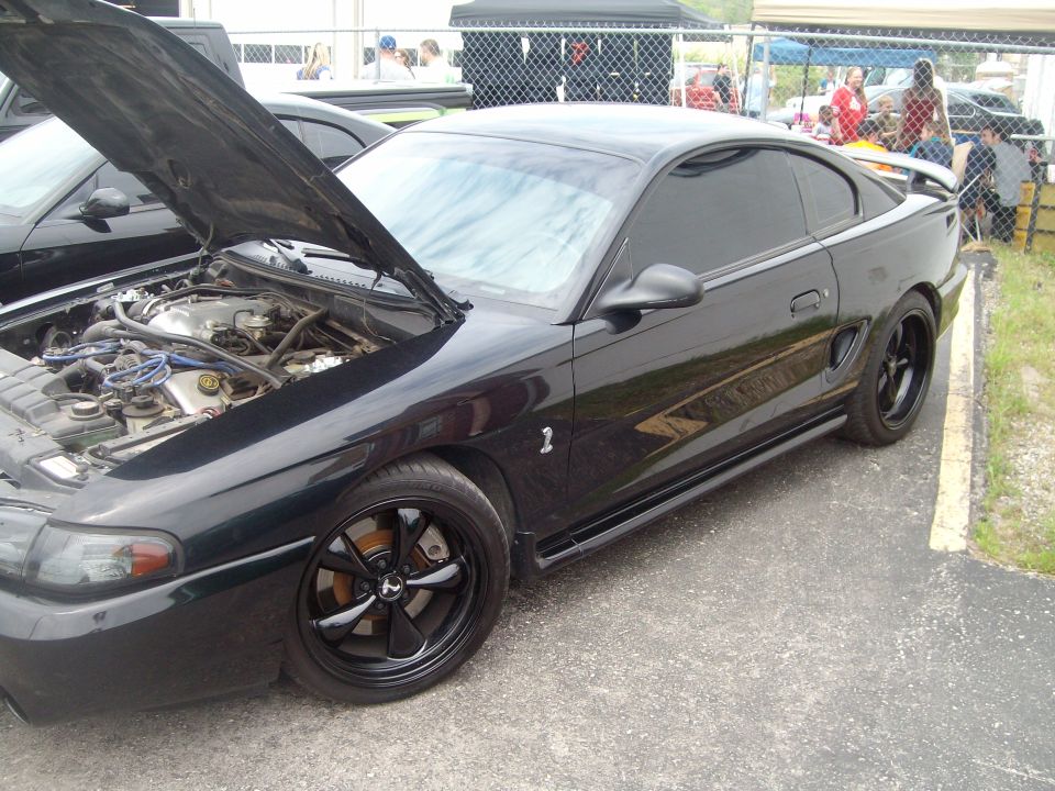 Black 1996 Ford Mustang Cobra with hood open, showing engine