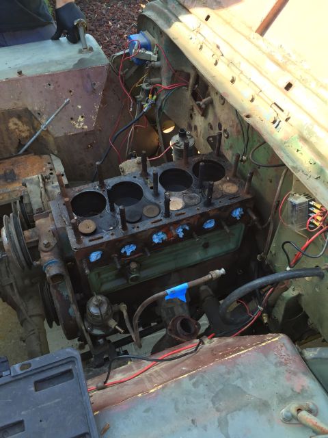 1946 Jeep Willys - The engine bay of a vehicle is shown with the engine block disassembled, indicating repair work in progress.