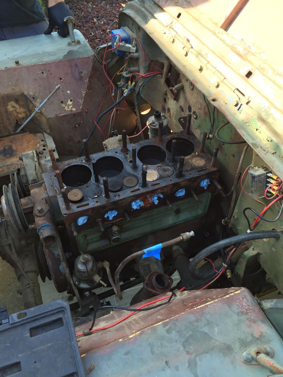 Engine bay with engine block exposed, undergoing repair