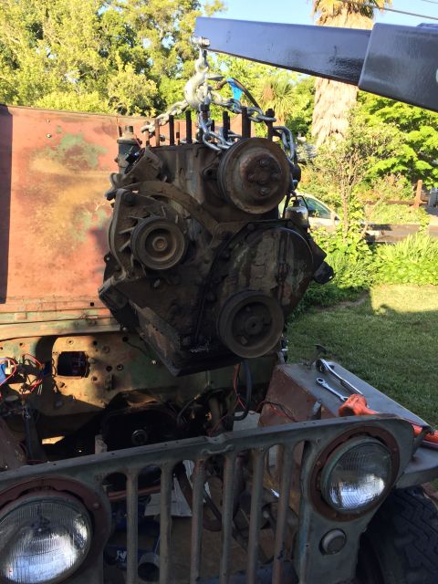 1946 Jeep Willys - Engine removal in progress for a 1946 Jeep CJ5, with a wrench resting on the fender.