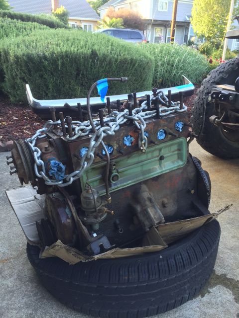 1946 Jeep Willys - An old engine block sits on a tire, ready for restoration or replacement.