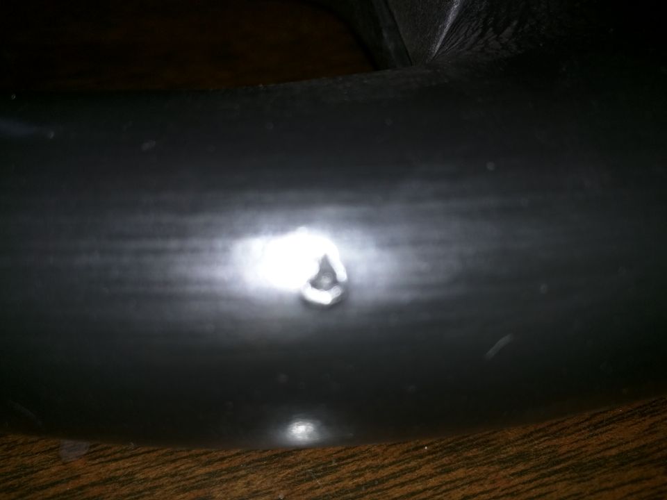 Close-up of a dark tire with a small dent or imperfection