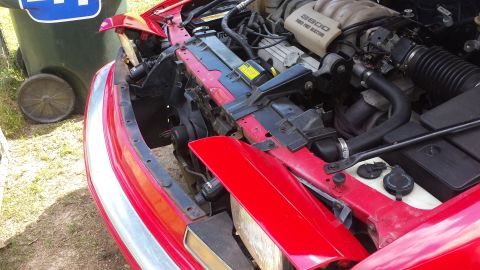 1991 Buick Reatta - The engine bay of a 1991 Buick Reatta shows the 3800 V6 engine and radiator.