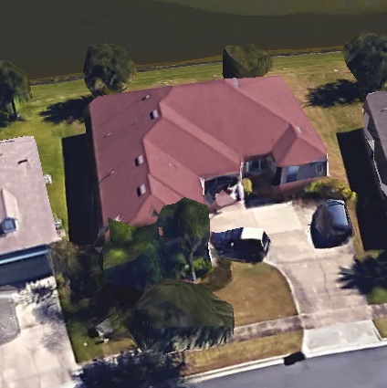 1994 Ford Bronco - Aerial view of a suburban house with two vehicles parked in the driveway.