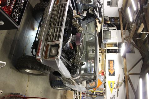 1979 Ford Bronco - The front end of a 1979 Ford Bronco is visible with its hood open, revealing the engine compartment.