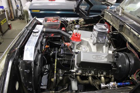 1979 Ford Bronco - Custom Ford V8 engine build with racing valve covers and headers. Another vehicle is visible in the background.
