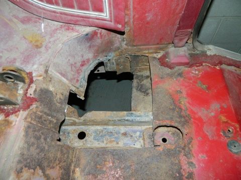 1979 Ford Bronco - Severe rust damage is visible on the vehicle's floor pan, indicating significant deterioration.