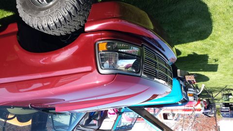 1995 Ford Bronco - This red 1995 Ford Bronco is shown from the front quarter angle, with its spare tire mounted on the rear.