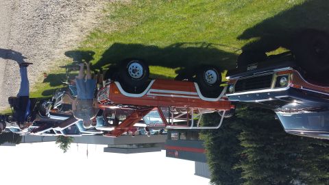 1995 Ford Bronco - This orange Ford Bronco, likely from the late 1970s, is on display with other vehicles.
