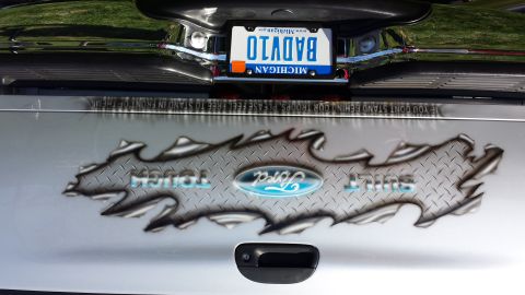 1995 Ford Bronco - The rear of a Ford truck features a custom decal and a Michigan license plate.
