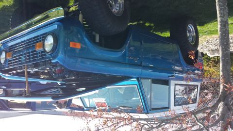 1995 Ford Bronco - This blue first-generation Ford Bronco features a white roof and a spare tire mounted on the rear. The vehicle appears to be from the mid-1…