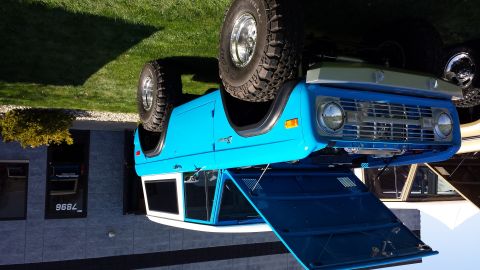 1995 Ford Bronco - This blue Ford Bronco features a white top and a classic grille design.