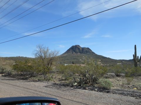 1995 Ford Bronco - A view of a desert mountain under a clear blue sky, with various desert plants in the foreground.