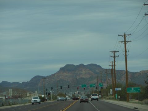 1995 Ford Bronco - A view from a vehicle traveling on a highway, with mountains and utility poles visible.